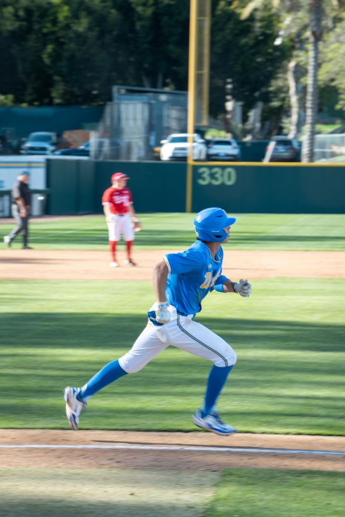 Infielder 7; Roman Marti. runs after hitting a fast pitch. After calming his senses down; he was able to bat against Nebraska's fastest pitcher.