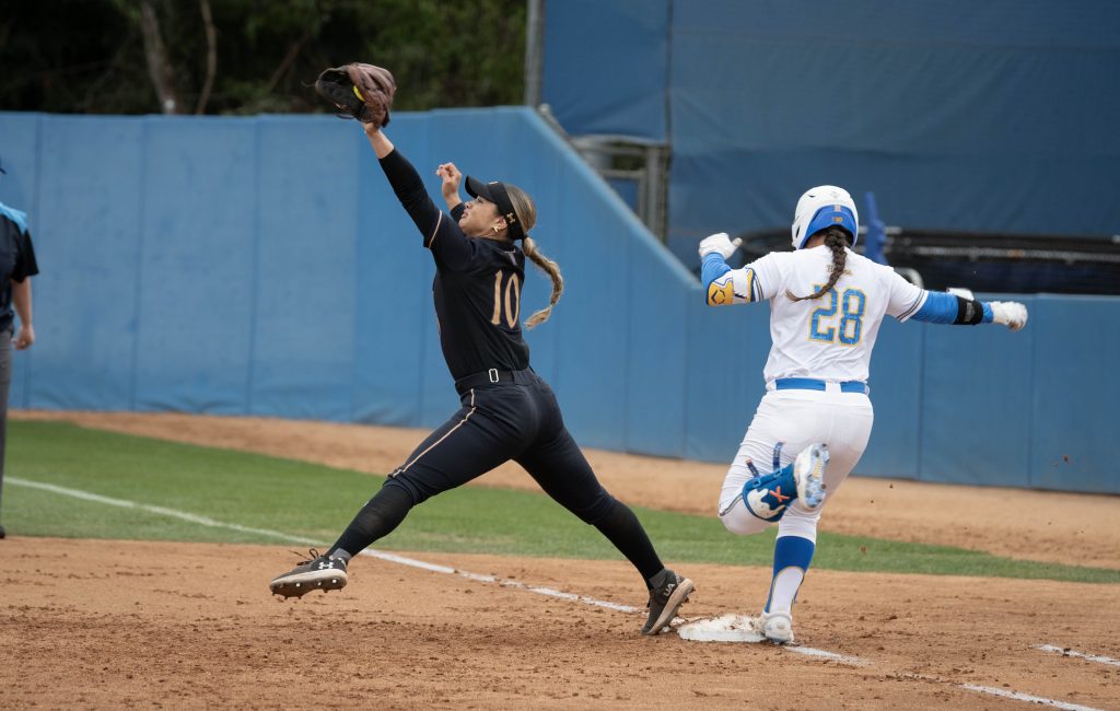 Alexis Ramirez darts to first base as its defender attempts to tag her out. Photographed by Sapna Drew/BruinLife.