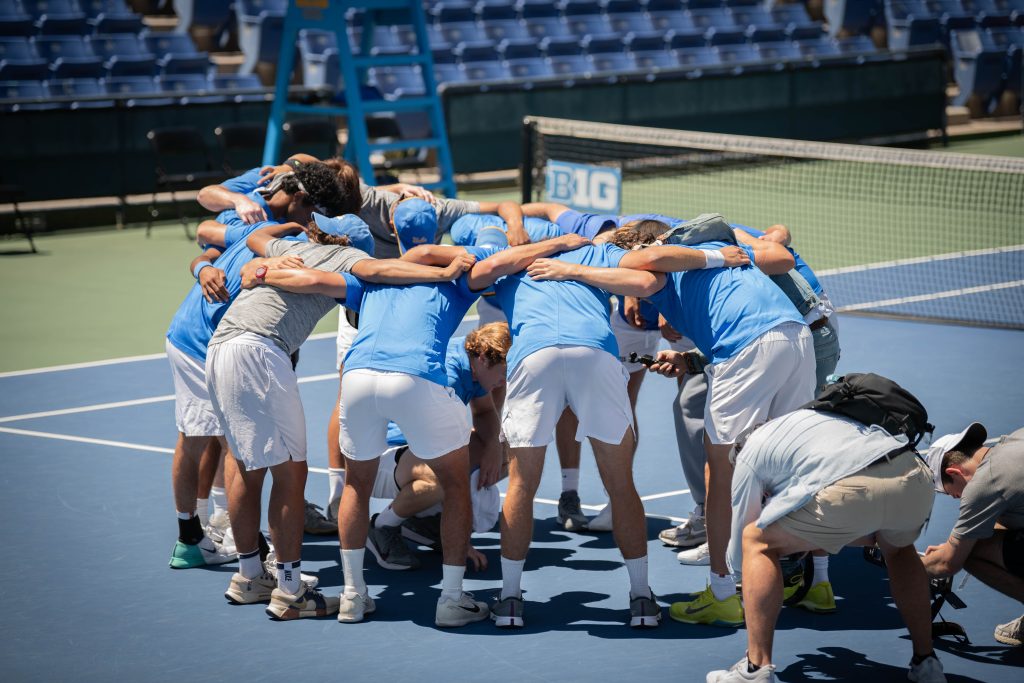 Players huddle before the game begins. Photographed by Sapna Drew/BruinLife.