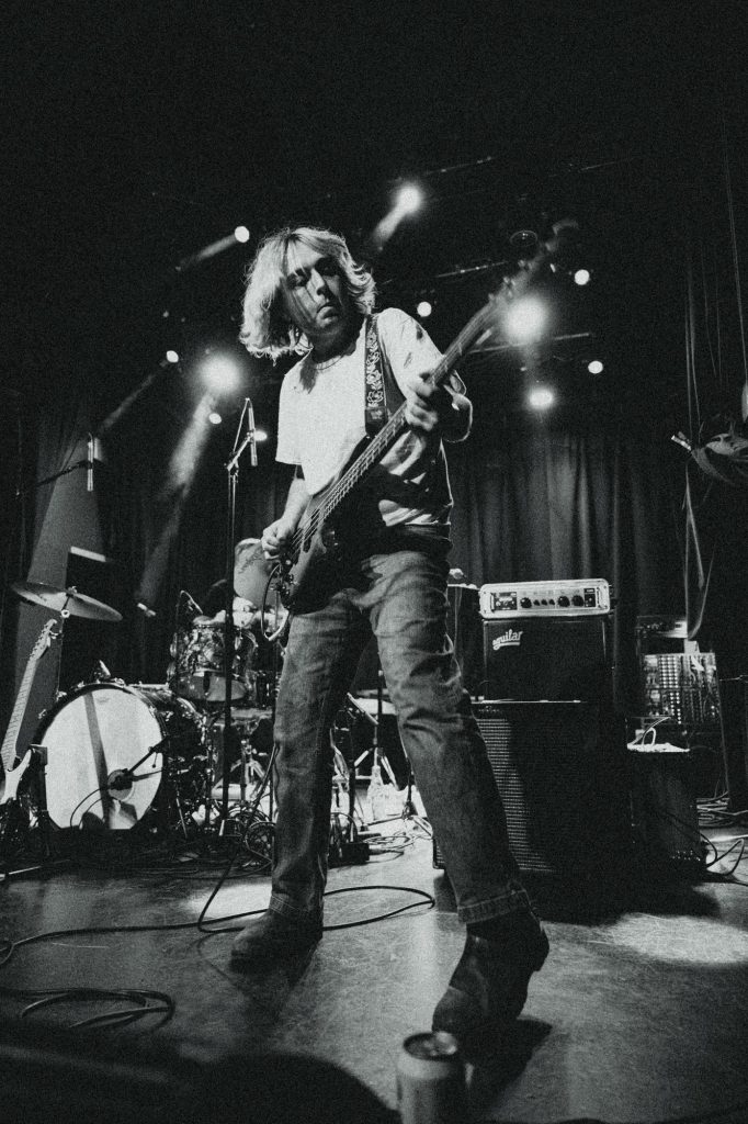 Fraser Bell, bass guitarist for Girl and Girl, takes the stage with raw energy. Photographed by Amy Miranda/BruinLife.