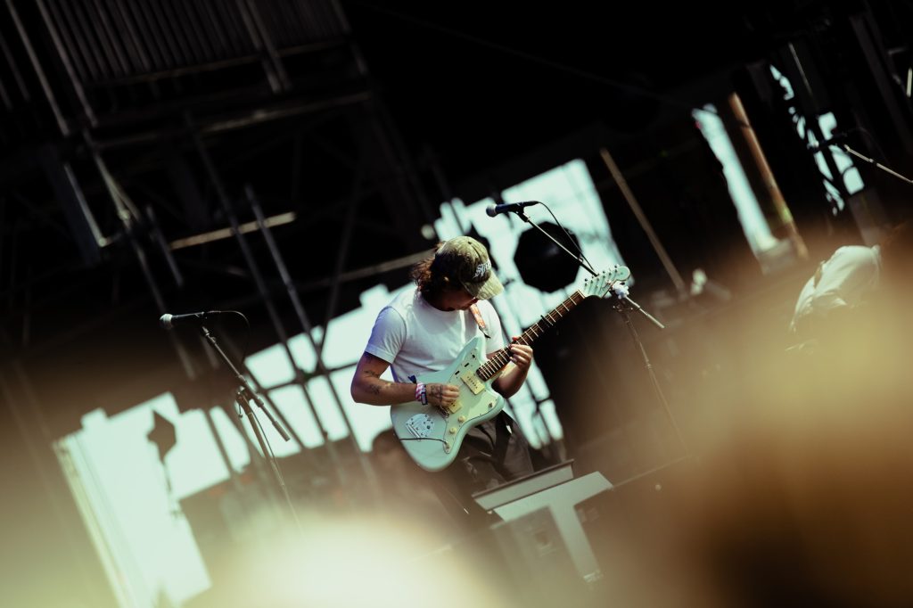 Campbell Burns strums his guitar with ease, blending dreamy melodies into Vacations’ laid-back sound. Photographed by Ryan Zhang/BruinLife.