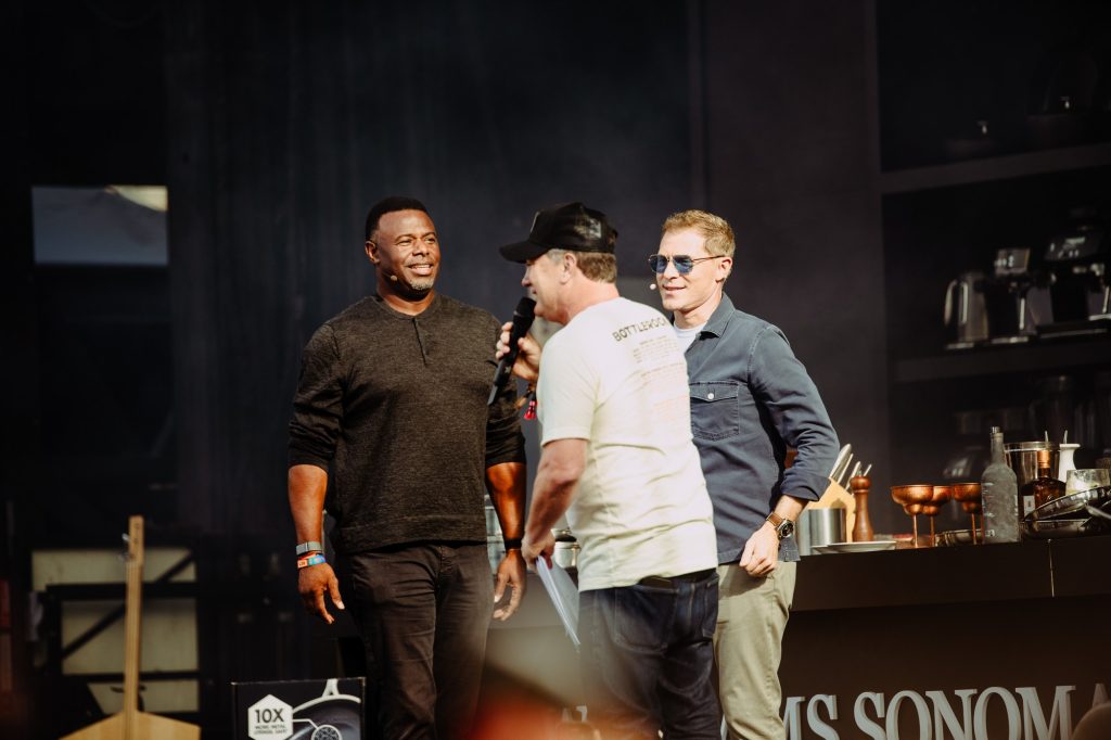 Bobby Flay and Ken Griffey Jr. make a grand entrance onto the Williams Sonoma Culinary Stage, greeted by cheers from the crowd. Photographed by Ryan Zhang.