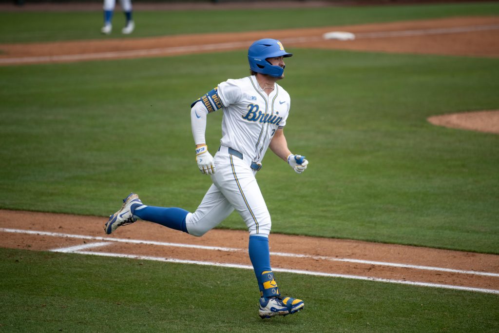 AJ Salgado runs to first base with confidence after driving a hit into play. Photographed by Maia Salti/BruinLife Photographed by Maia Salti/BruinLife