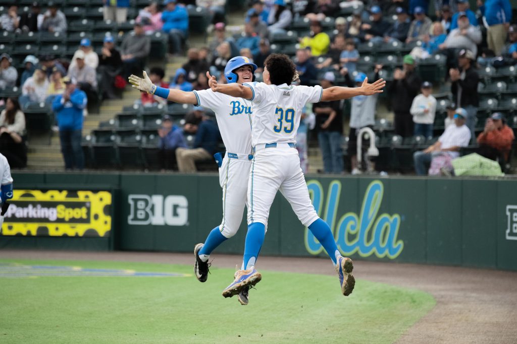 Roman Martin (#7) and Mulivai Levu (#39) celebrate with a mid-air chest bump after Martin's home run. Photographed by Maia Salti/BruinLife