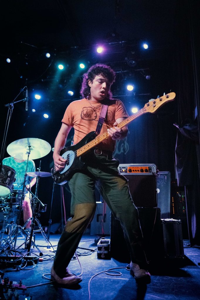 Gianni Aiello, bassist and vocalist for Naked Giants, brings dynamic energy to the stage. Photographed by Amy Miranda/BruinLife.