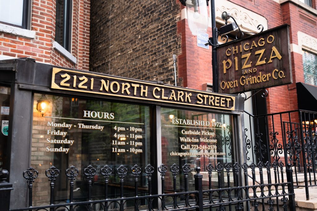 Chicago Pizza and Oven Grinder Co. presents a rather conservative façade that conceals its deep, low-lit wooden paneled interior. The establishment held more history than just inventing the pizza pot pie: across the street, in 1929, the Saint Valentine's Massacre saw the assassination of seven North Side Gang members. Photographed by Finn Martin/BruinLife.