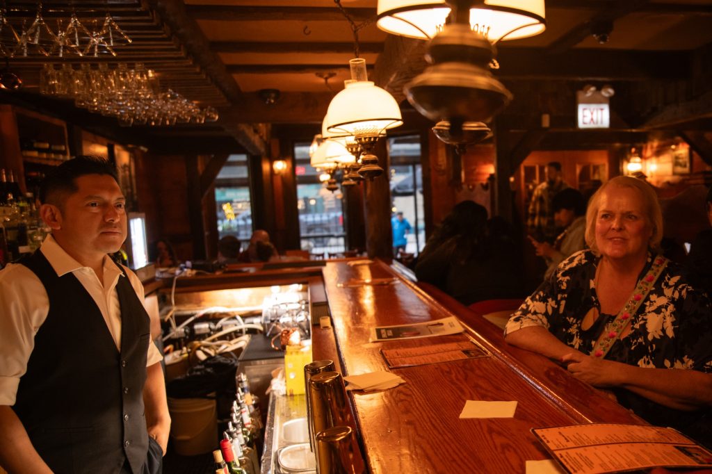 Ever (left) and Lisa (right) sit at the bar to share the recent history of the Chicago Pizza Oven and Company. Under Lisa's ownership and Ever's ingenuity, the restaurant expanded its bar options beyond just the classics. Photographed by Finn Martin/BruinLife.