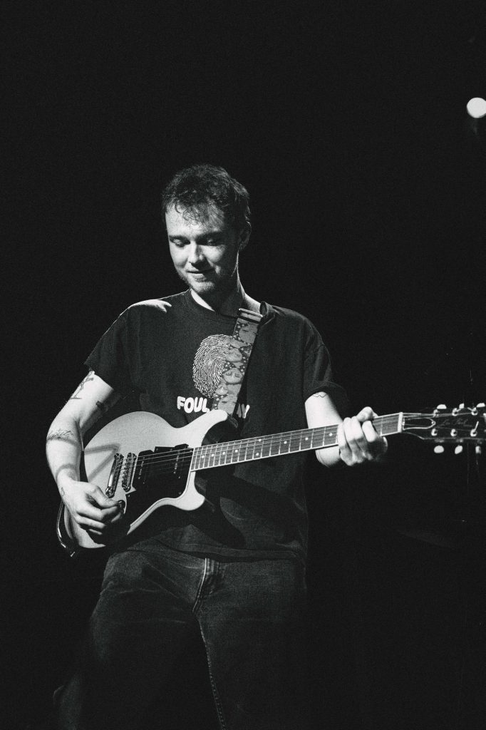 Grant Mullen, guitarist and vocalist for Naked Giants, brings a laid-back vibe to the performance as he plays. Photographed by Amy Miranda/BruinLife.