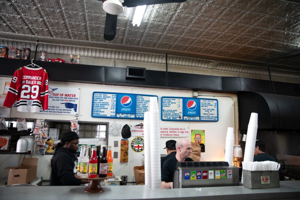 The cooks tend the flames and the customers. Photographed by Finn Martin/BruinLife.