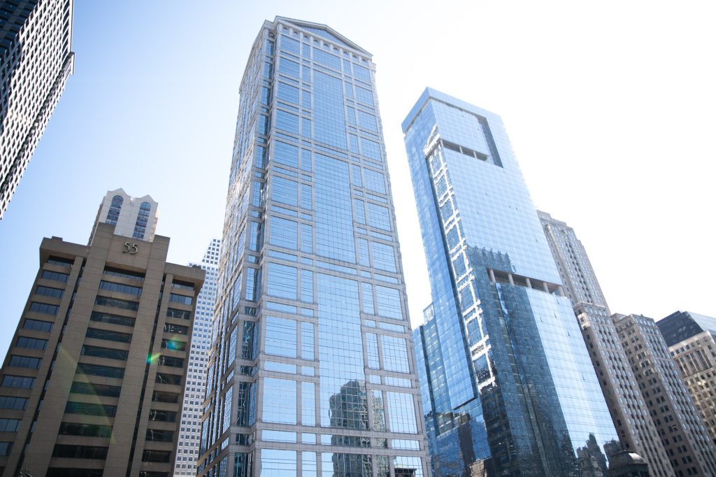 The skyscraper on the left reflecting the blue sky was designed in the postmodern style to emulate the Greek Parthenon. To that building's left is building 55, a stout, brutalist scraper. Photographed by Finn Martin/BruinLife.