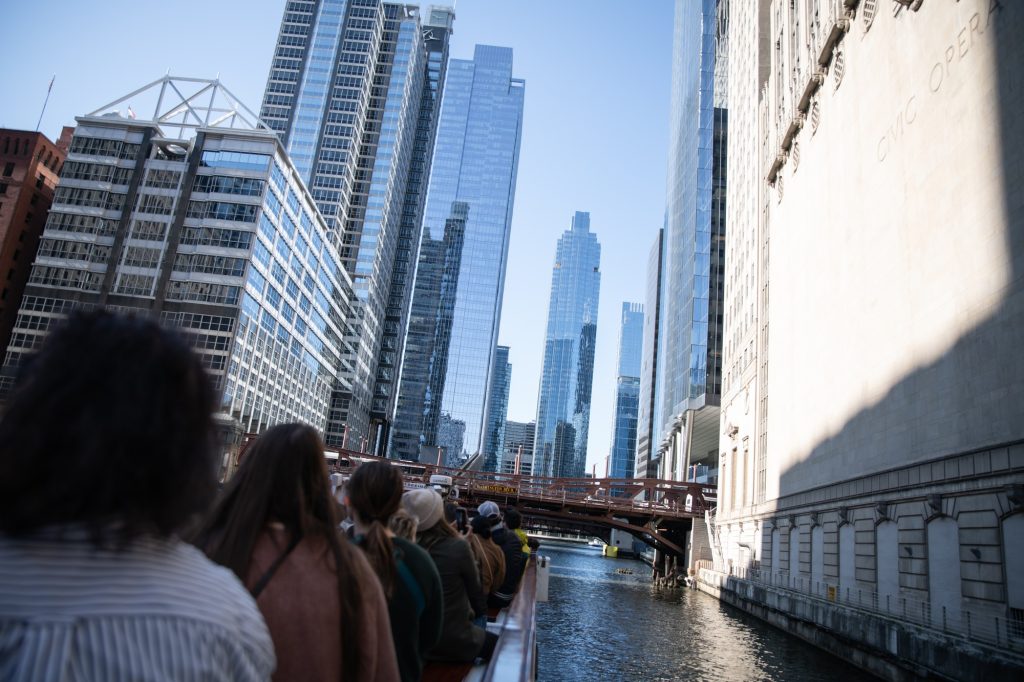 Many buildings along the Chicago River were built right at the river's edge without windows facing out onto the water, mostly for disgust of the river's poor quality in the pre 20th century. The boat passes by the Civic Opera building here. Photographed by Finn Martin/BruinLife.