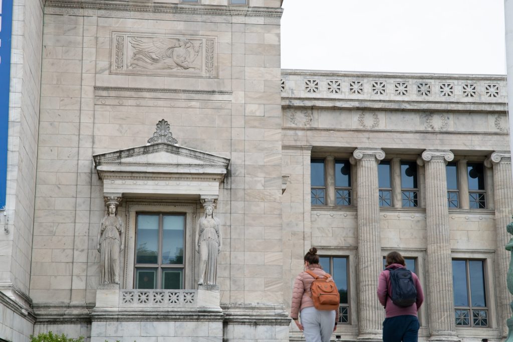 Two tourists stand by the museum's exterior. Photographed by Finn Martin/BruinLife.