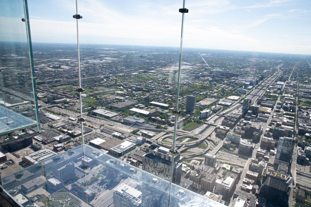 The ledge cantilevers tourists out of the building with only an inch-and-a-half of glass between them and a 103-story drop. Photographed by Finn Martin/BruinLife.