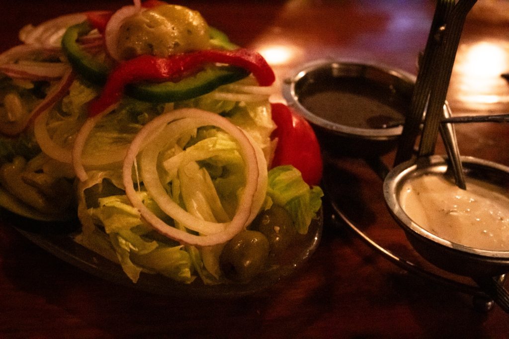 We are recommended the Chef&squot;s Salad by a man dubbed "El Muerte" by his co-workers. The two sauces -- a sour cream garlic dressing and a sweet and sour poppy seed -- had to be refilled halfway through our course they were so popular. Photographed by Finn Martin/BruinLife.