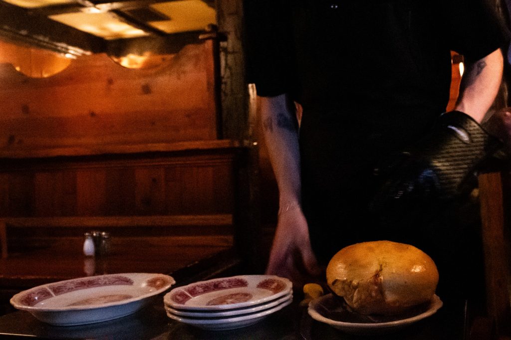 Served with a pound of Wisconsin Brick Cheese, the Pot Pie must be flipped and cracked at the table. The idea for the Pizza Pot Pie came to its inventor and Chicago Pizza Oven and Grinder Co. founder Albert Beaver in the form of a dream one night. Photographed by Finn Martin/BruinLife.