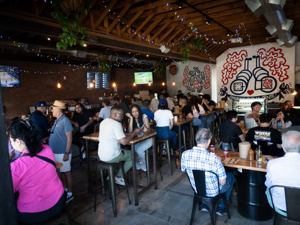 Seating can be scarce at Moo's, but customers who finally do find an indoor tabletop enjoy an island in a sea of islands to dig into meats and sides. Photographed by Finn Martin/BruinLife.
