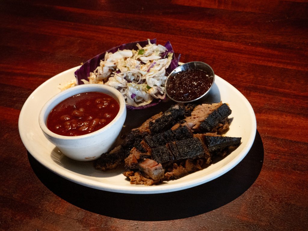 A testament to the art of pitmasterhood, this tender brisket comes apart with a simple touch of a spoon and serves up a light and juicy bite. Match this with the accompanying chipotle sauce for a wonderful meal. Photo by Finn Martin/BruinLife.