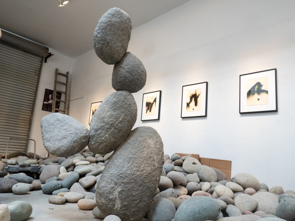 Experimenting with the heap of stones he's collected over the years from seas across the world, Woods Davy stacks the rocks together into gravity defying compositions using steel wiring. Photographed by Finn Martin/BruinLife.