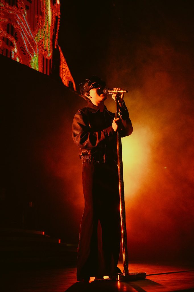 Cornejo grips the mic stand during a powerful verse. Photographed by Amy Miranda/BruinLife