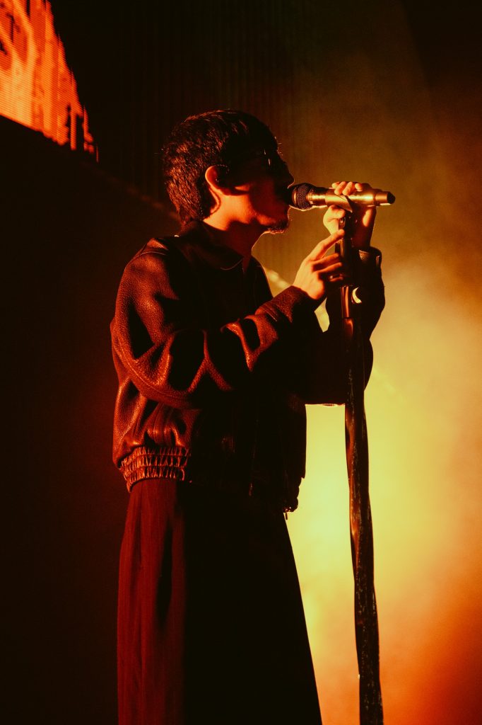 Iván Cornejo sings into the mic stand, delivering a heartfelt performance. Photographed by Amy Miranda/BruinLife