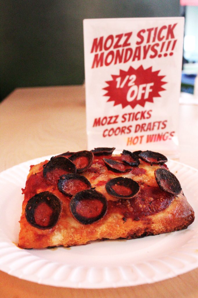 In front of the advertisement, customers will find the New York slice's doughier brother — the Sicilian slice. Photo by Gavin Meichelbock.